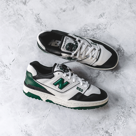 New Balance 550 sneakers in white, green, and black.