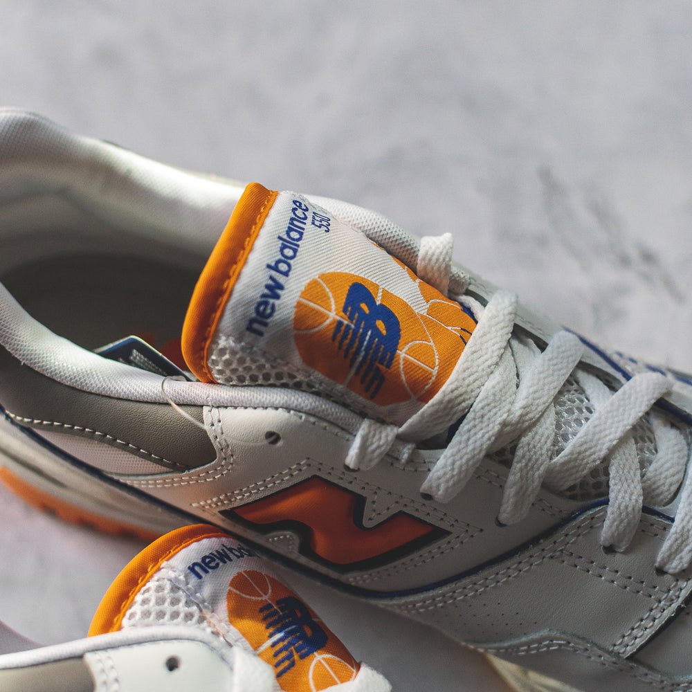 New Balance 550 White Sneakers with Vibrant Orange Details