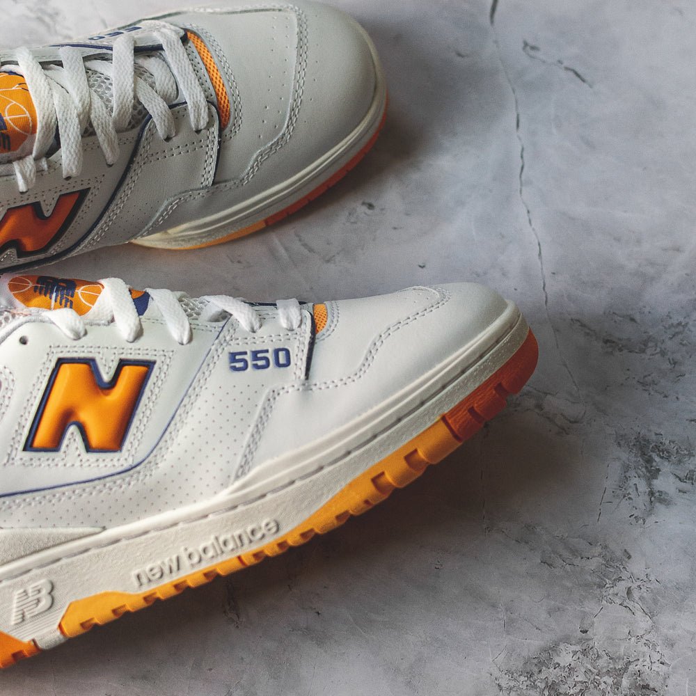 New Balance 550 White Sneakers with Vibrant Orange Details